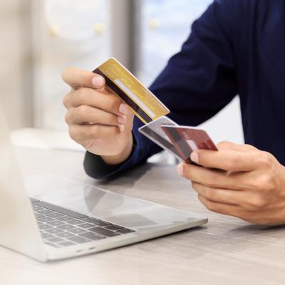 Man holding multiple credit cards.