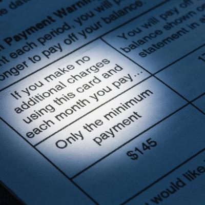 A close up view on the minimum payment terms in a credit card bill.