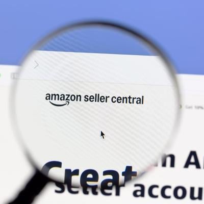 A magnifying glass over 'Amazon Seller Central' page.