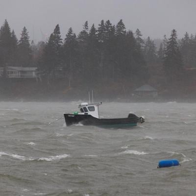 A lobster boat at sea during a storm in the North Haven Harbor, Maine.