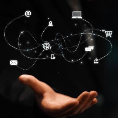 A network of marketing and communication concept icons over a person's hand.