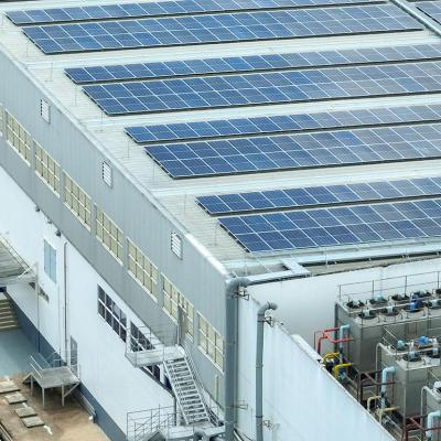 A warehouse building with solar panels on the rooftop.