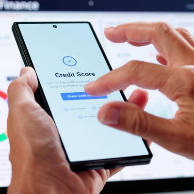 Person checking credit score online using smartphone.