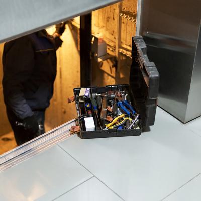 A specialist inside an elevator shaft to repair systems.