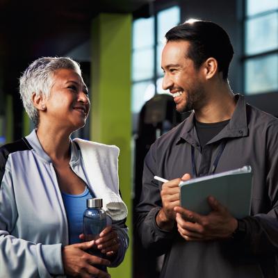 A middle aged woman with her gym trainer.