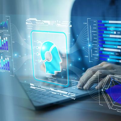 A businessman using AI-powered CRM technology on a laptop.