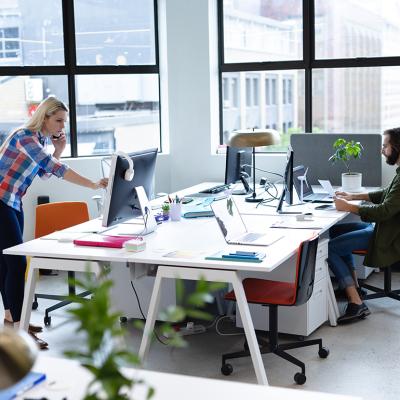 Two businesspeople working in a creative office.