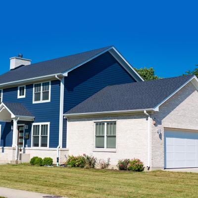 A blue and white modern, suburban home in a residential neighborhood.