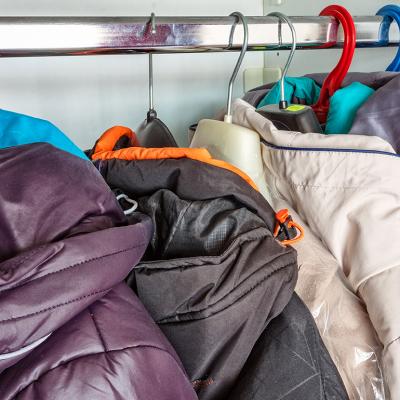 Winter jackets in a closet hanger.