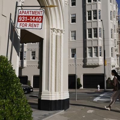 An apartment for rent sign hangs outside of an apartment building in San Francisco, California.
