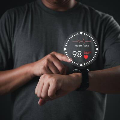A man using smartwatch illustrated with heart rate monitor graphics.