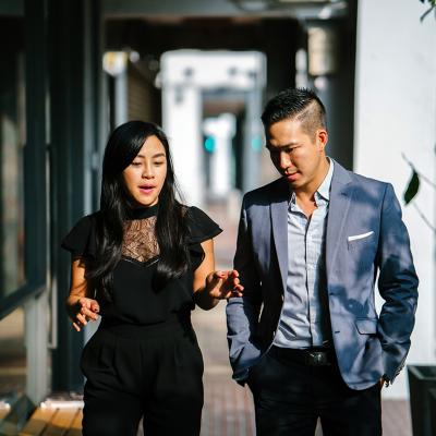 A pair of business people walking along a corridor.