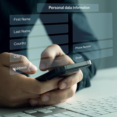 Person typing on smartphone illustrated with personal data sheet graphics.