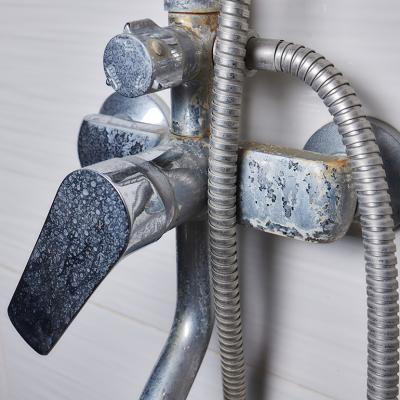 An old tap aerator with marks of hard water.