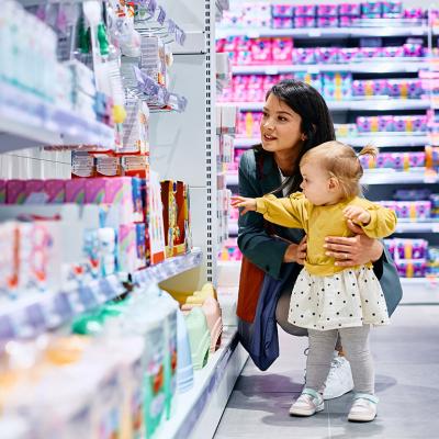 A mother and her young daughter shopping in a drugstore.