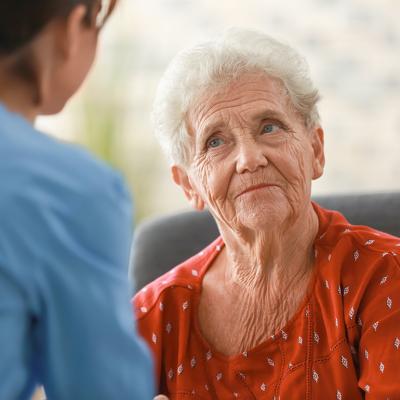 A senior woman facing her nurse.