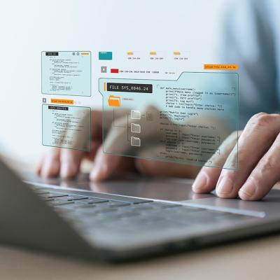 Person typing on a laptop keyboard illustrated with programming app graphics.