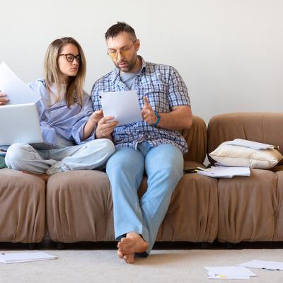 A couple reviewing documents at home.