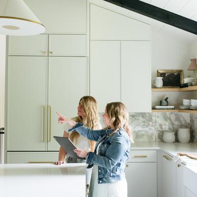 Two people checking out a design or structure in a kitchen.