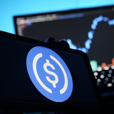 A stablecoin logo displayed on a smartphone.