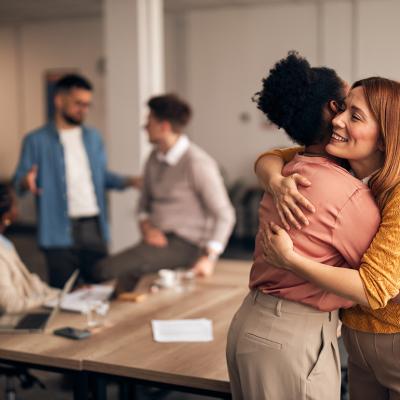 An office worker embracing a colleague. 