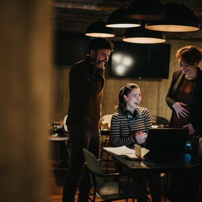 Coworkers having a fun conversation in their office.