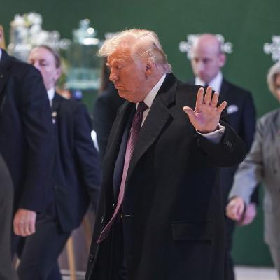 US President Donald Trump waves at the press, who appeared to be frowning in a world summit in Davos, Switzerland.