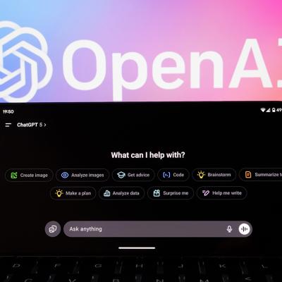 ChatGPT 5 interface on a phone with the logo of OpenAI in the background.