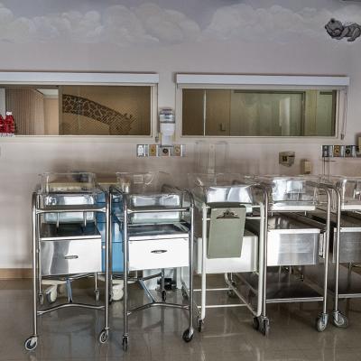 Empty infant beds in a corner of a maternity ward.