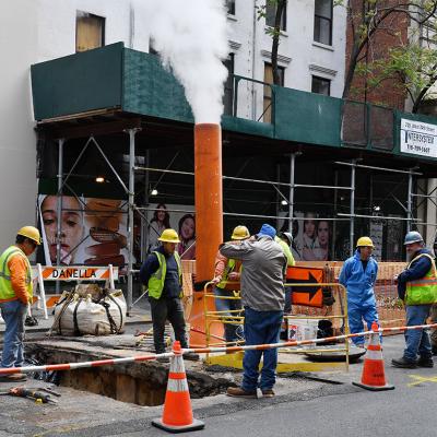 A team of workers on a roadside construction site in New York.