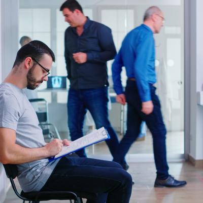 A person filing a document in a hospital waiting area.
