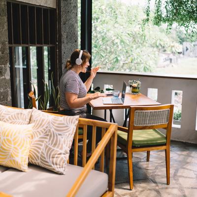 A freelancer working remotely from a home balcony. 