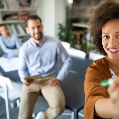 Employees collaborating during a meeting in the office.