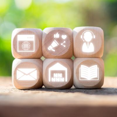 Wooden blocks with icons representing omni channel marketing and communication concepts.