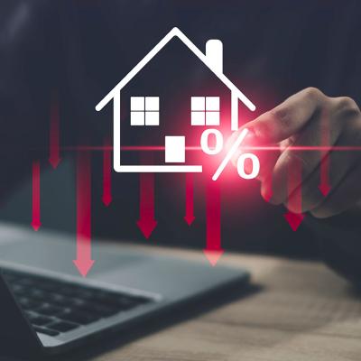 Person using a laptop illustrated with graphics showing concept of lower costs of housing.