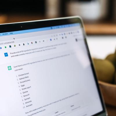 A laptop screen showing a ChatGPT prompt on meal planning.