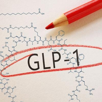 ‘GLP-1’ text emphasized on paper, with a chemical structure in the background.