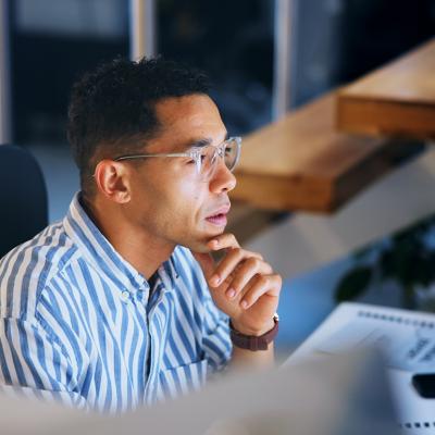 A focused businessman working at night in an office.