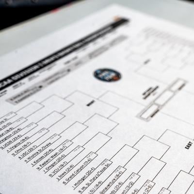 A selective focus shot on the Western Region part of a printed NCAA tournament bracket.
