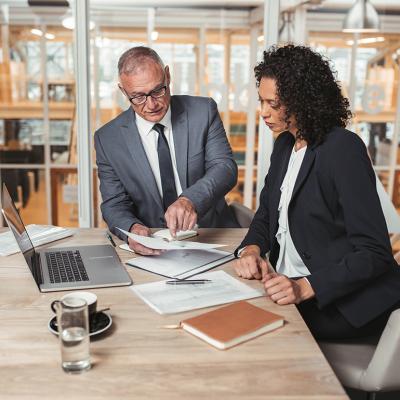 Two business executives reviewing a report.