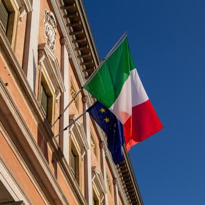 Italy and European Union flags on a balcony of a building in Reggio Emilia City, Italy. 