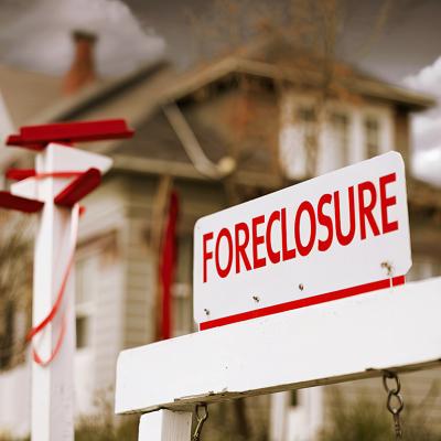 A foreclosure sign seen in front of a house.