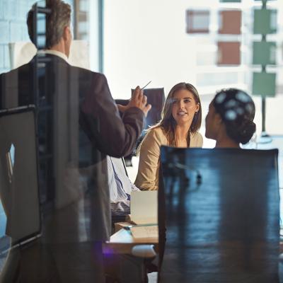 A manager discussing during an office meeting. 