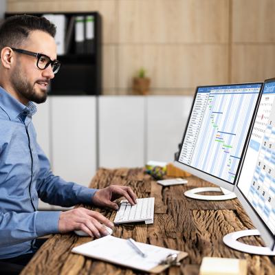 An employee working on calendar scheduling and staff time sheet.
