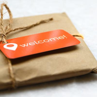 A brown package with an orange welcome tag.