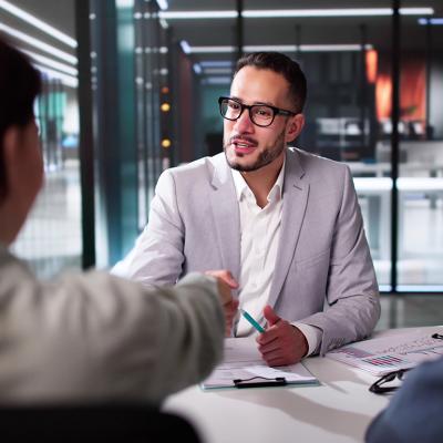 A tax advisor shaking hands with a client.