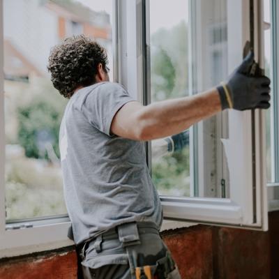 A window installer assembling a new unit of windows for a home.