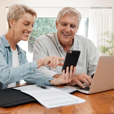 An elderly couple working on their retirement documents at home.
