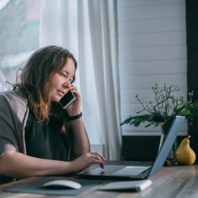 A person using a laptop and working from home. 