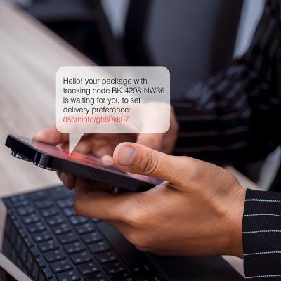 Person using phone with an illustration of an SMS bubble showing potential scam with phishing link.